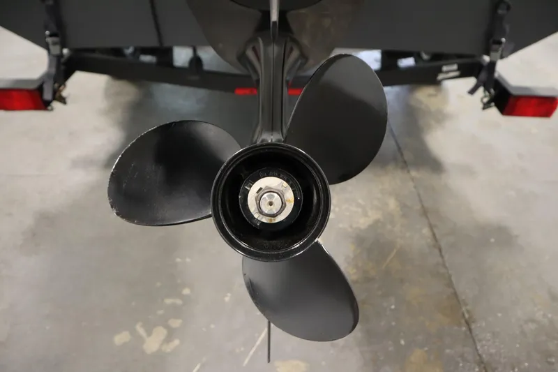 Slide: The Image of 2017 Tracker 20 CW Pontoon boat propeller close-up in a garage setting. - 45
