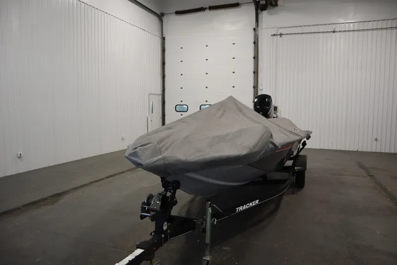 Slide: The Image of 2017 Tracker 20 CW Pontoon boat covered in a garage setting. - 49