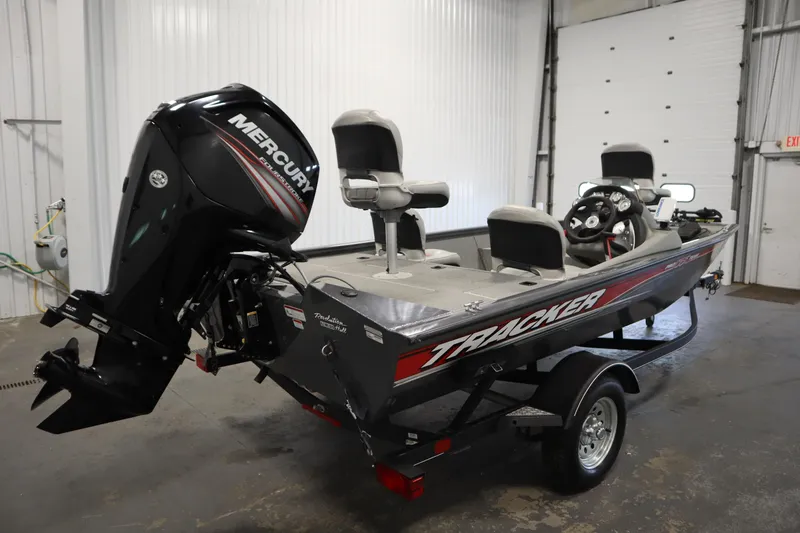 Slide: The Image of 2017 Tracker 20 CW Pontoon boat with Mercury outboard motor in a garage setting. - 5
