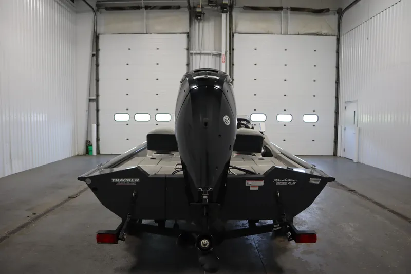 Slide: The Image of 2017 Tracker 20 CW Pontoon boat in a garage, rear view. - 6