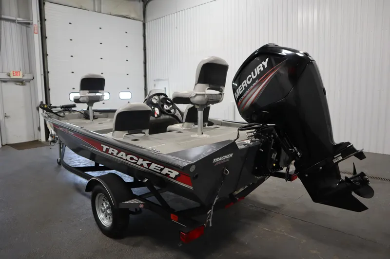 Slide: The Image of 2017 Tracker 20 CW Pontoon boat with Mercury engine in a garage setting. - 7