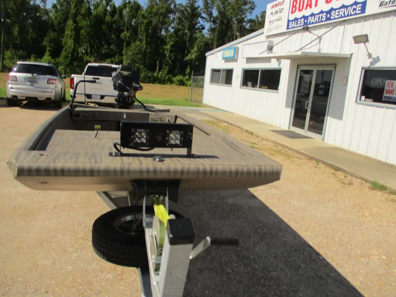 Slide: The Image of 2025 Gator Tail 1754 Extreme boat on trailer outside dealership. - 7