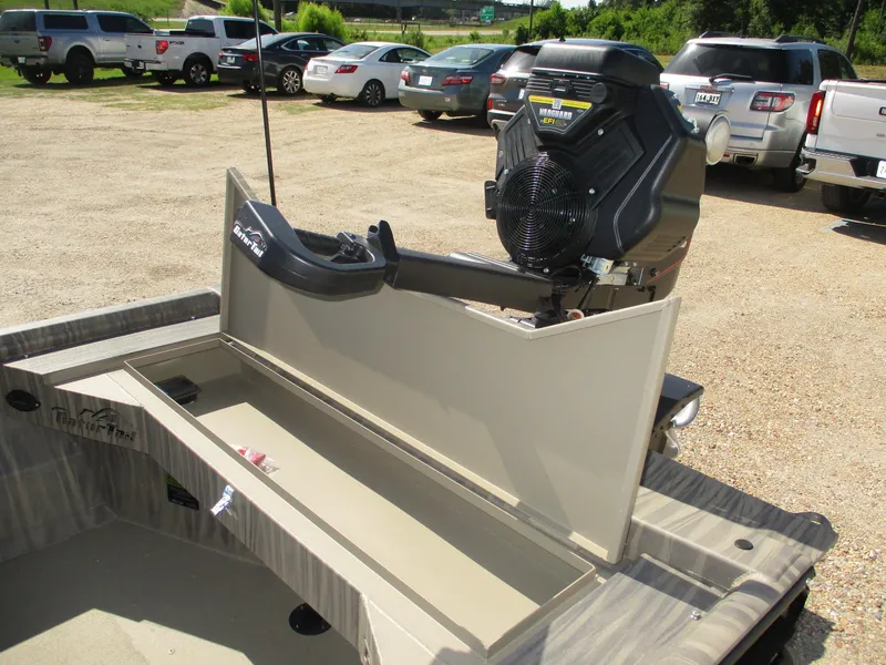 Slide: The Image of 2025 Gator Tail 1754 Extreme boat with open storage compartment and motor in parking lot. - 9