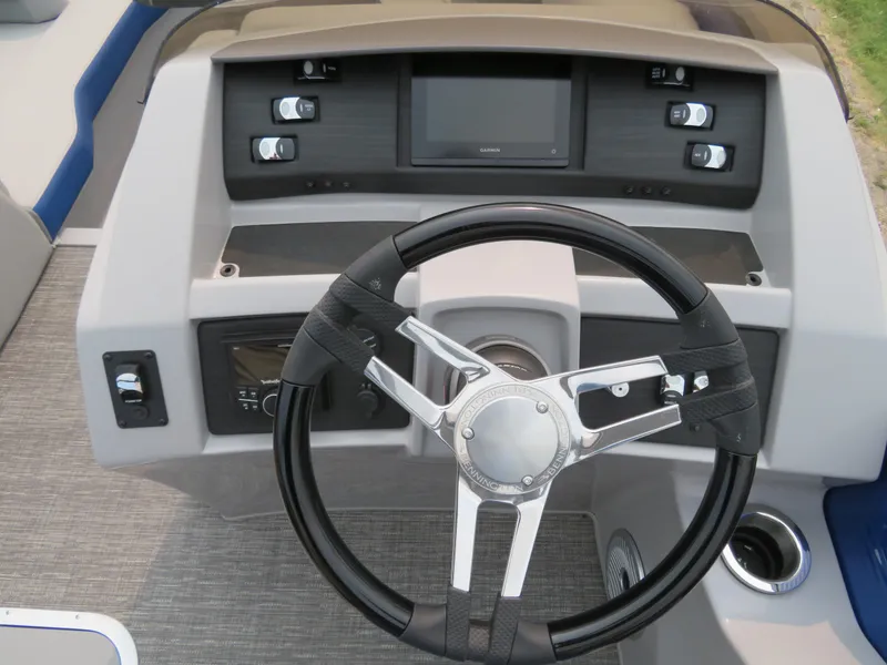 Slide: The Image of 2024 Bennington 25 LTSB boat dashboard with steering wheel and control panel. - 11