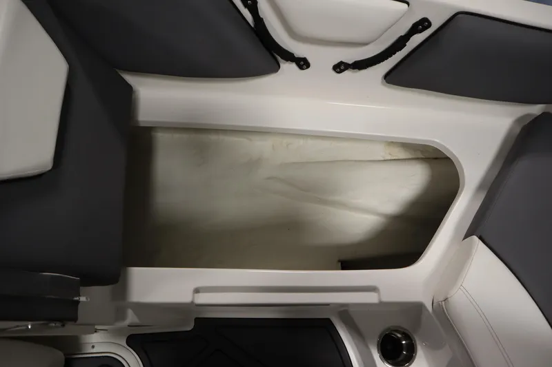 Slide: The Image of 2023 Heyday WT Surf boat interior storage compartment with sleek design and dark upholstery. - 16