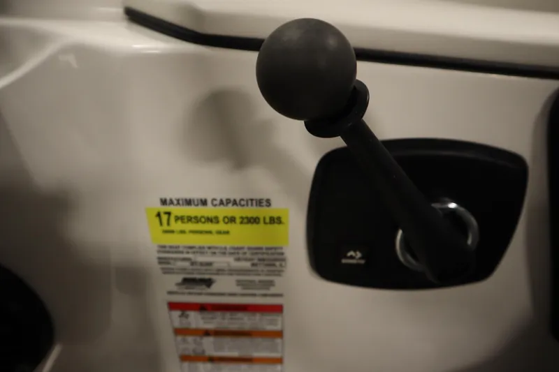 Slide: The Image of Control lever and capacity label on 2023 Heyday WT Surf boat, indicating 17-person limit. - 26