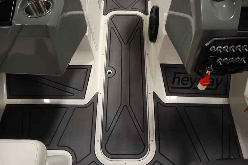 Slide: The Image of 2023 Heyday WT Surf boat interior with sleek black flooring and control panel. - 33