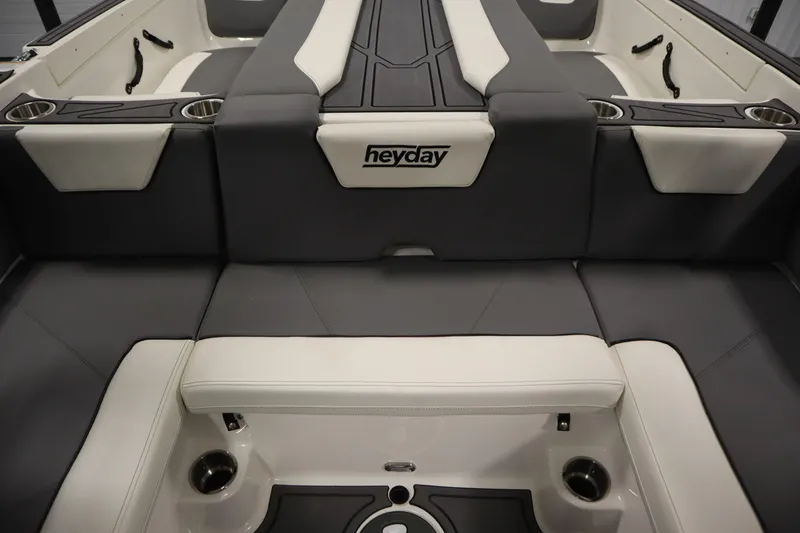 Slide: The Image of 2023 Heyday WT Surf boat interior with gray and white seating and cup holders. - 39