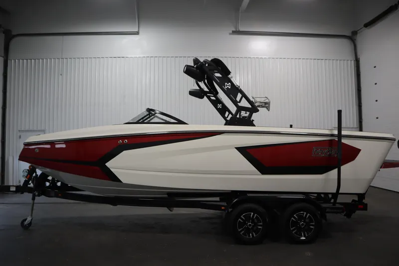 Slide: The Image of 2023 Heyday WT Surf boat in a showroom, featuring a sleek red and white design. - 8