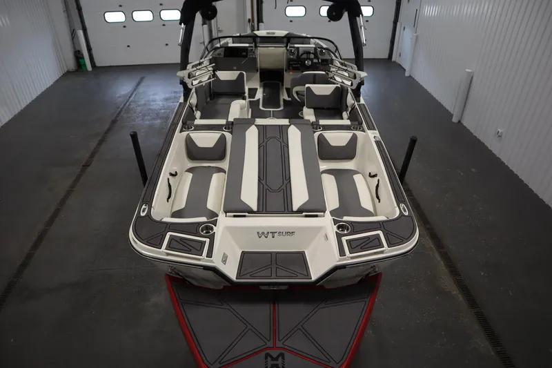 Slide: The Image of 2023 Heyday WT Surf boat interior, showcasing sleek seating and modern design in a garage setting. - 10