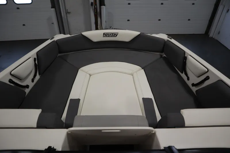 Slide: The Image of 2023 Heyday WT Surf boat interior with gray and white seating. - 11