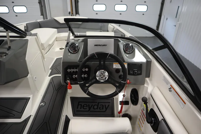 Slide: The Image of 2023 Heyday WT Surf boat interior with steering wheel and dashboard controls. - 19