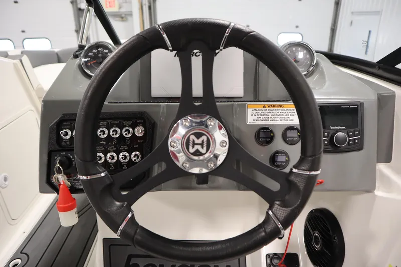 Slide: The Image of 2023 Heyday WT Surf boat dashboard with steering wheel and control panel. - 20