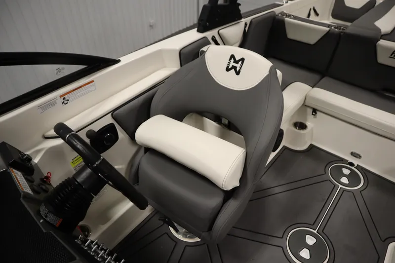 Slide: The Image of 2023 Heyday WT Surf boat interior with steering wheel and cushioned seating. - 28