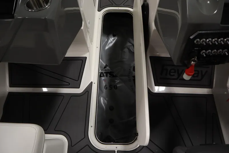 Slide: The Image of 2023 Heyday WT Surf boat interior with storage compartment and control panel. - 34