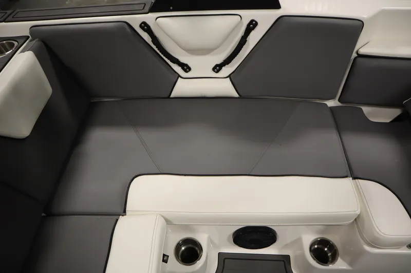Slide: The Image of 2023 Heyday WT Surf boat interior with gray and white seating and cup holders. - 37