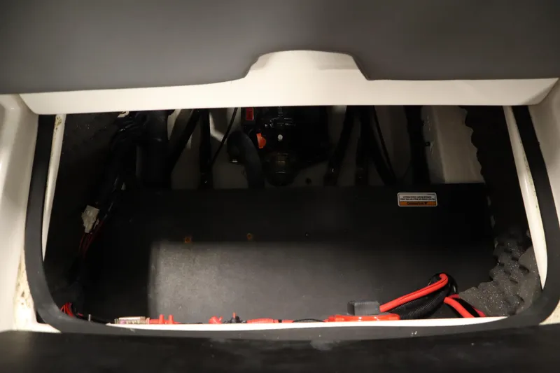 Slide: The Image of 2023 Heyday WT Surf boat interior compartment with wiring and components. - 40