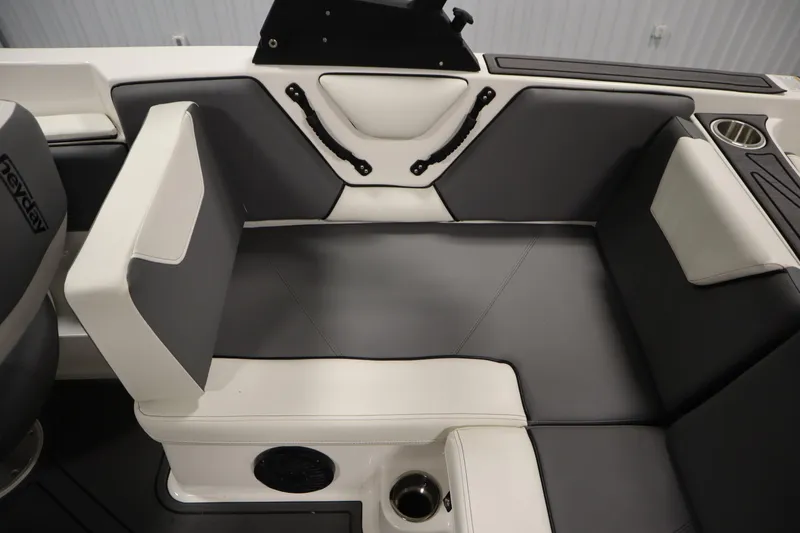 Slide: The Image of 2023 Heyday WT Surf boat interior with gray and white seating, cup holder, and speaker. - 42