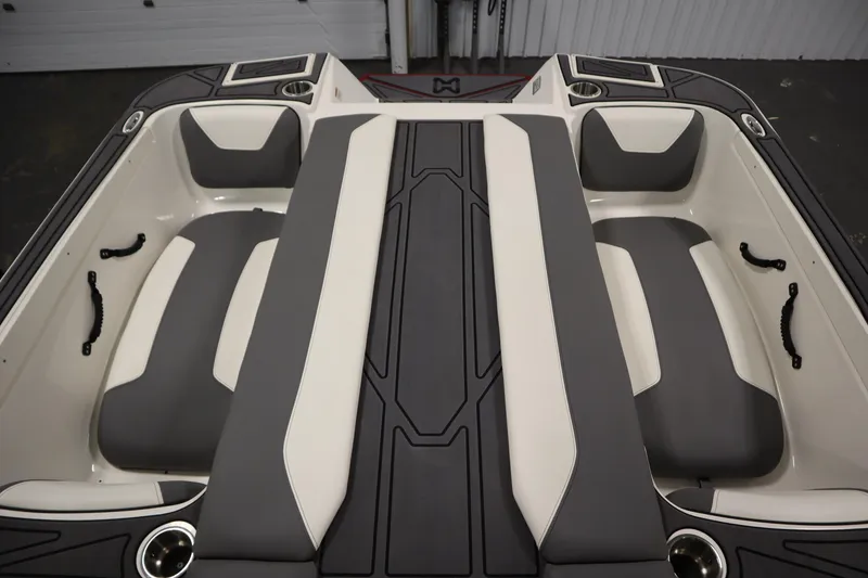 Slide: The Image of 2023 Heyday WT Surf boat interior with gray and white seating and cup holders. - 48
