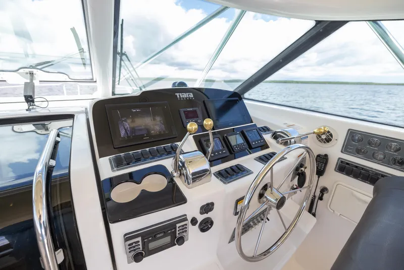 Slide: The Image of Helm of 2004 Tiara Yachts 4200 Open on open water. - 24