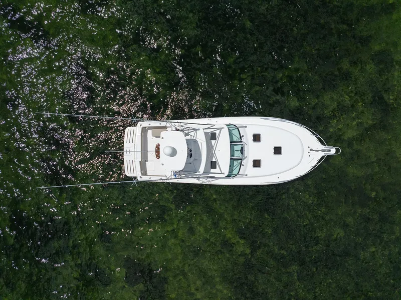 Slide: The Image of Aerial view of 2004 Tiara Yachts 4200 Open on green water. - 9
