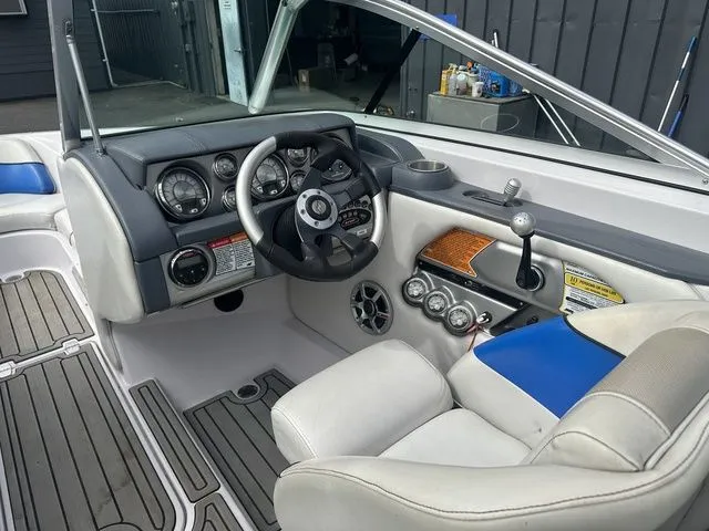 Slide: The Image of 2007 Nautique Super Air Nautique 210 boat interior with steering wheel and dashboard controls. - 10