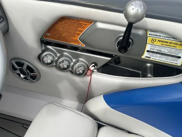 Slide: The Image of 2007 Nautique Super Air Nautique 210 dashboard with gauges and capacity warning. - 13