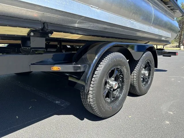Slide: The Image of 2025 Harris Cruiser 210 CWDH trailer with dual black wheels in a parking lot. - 15