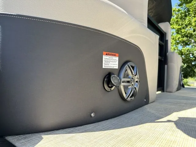 Slide: The Image of 2025 Harris Cruiser 210 CWDH boat interior with speaker and warning label. - 16