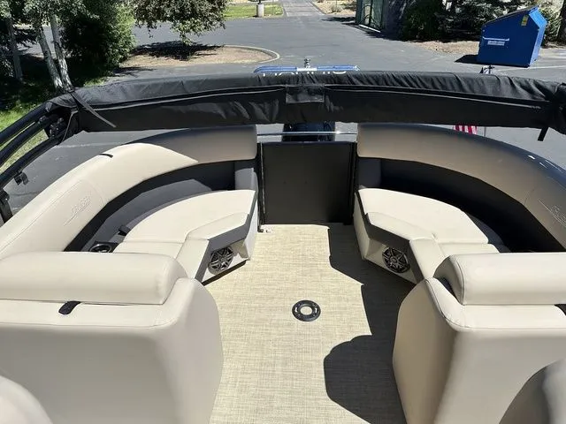 Slide: The Image of 2025 Harris Cruiser 210 CWDH pontoon boat with beige seating and spacious deck area. - 17