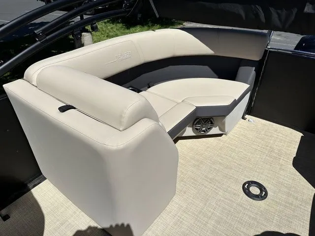 Slide: The Image of 2025 Harris Cruiser 210 CWDH boat interior with beige seating and carpeted floor. - 18