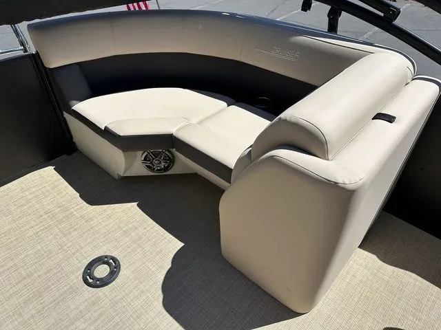 Slide: The Image of 2025 Harris Cruiser 210 CWDH boat interior with beige seating and speaker. - 19