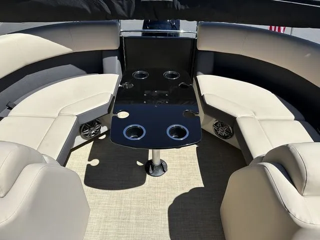 Slide: The Image of 2025 Harris Cruiser 210 CWDH boat interior with beige seating and cup holders. - 20