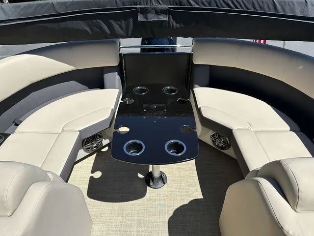 Slide: The Image of 2025 Harris Cruiser 210 CWDH interior with beige seating and black table. - 21