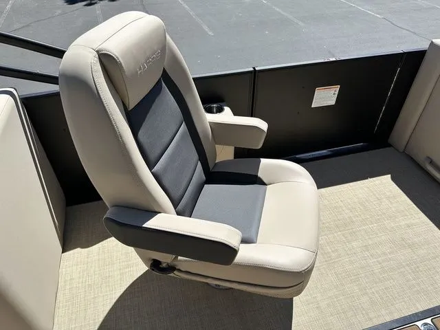 Slide: The Image of 2025 Harris Cruiser 210 CWDH boat seat, beige and black, on deck. - 23