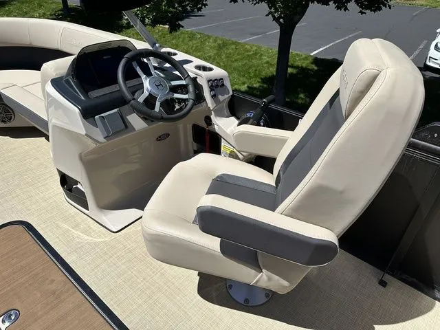 Slide: The Image of 2025 Harris Cruiser 210 CWDH boat interior with steering wheel and captain's chair. - 24