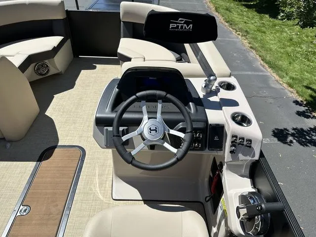 Slide: The Image of 2025 Harris Cruiser 210 CWDH boat interior with steering wheel and seating. - 25