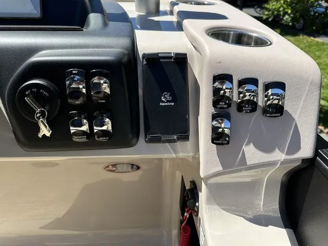 Slide: The Image of Control panel of 2025 Harris Cruiser 210 CWDH with switches and ignition key. - 28