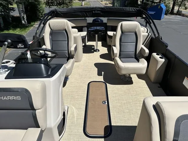 Slide: The Image of 2025 Harris Cruiser 210 CWDH pontoon boat interior with plush seating and modern helm. - 29