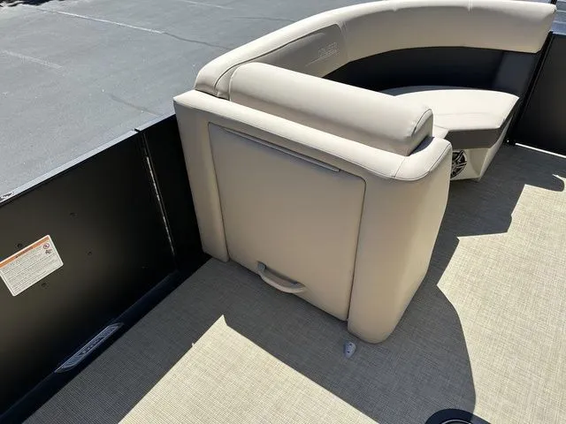 Slide: The Image of 2025 Harris Cruiser 210 CWDH boat interior with beige seating and flooring. - 30