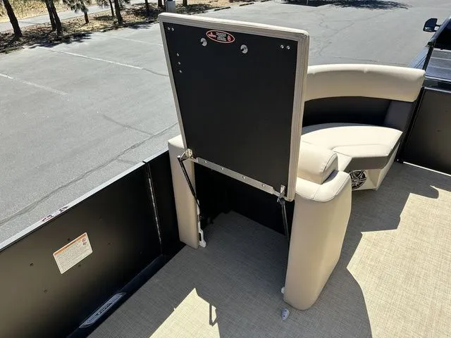 Slide: The Image of 2025 Harris Cruiser 210 CWDH boat interior with beige seating and black panel. - 31