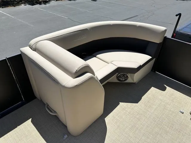 Slide: The Image of 2025 Harris Cruiser 210 CWDH boat interior with beige seating and speaker system. - 32