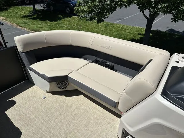 Slide: The Image of 2025 Harris Cruiser 210 CWDH boat interior with beige seating and cup holders. - 33