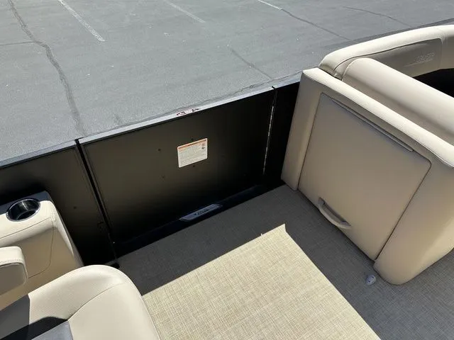 Slide: The Image of 2025 Harris Cruiser 210 CWDH interior with beige seating and cup holder. - 34