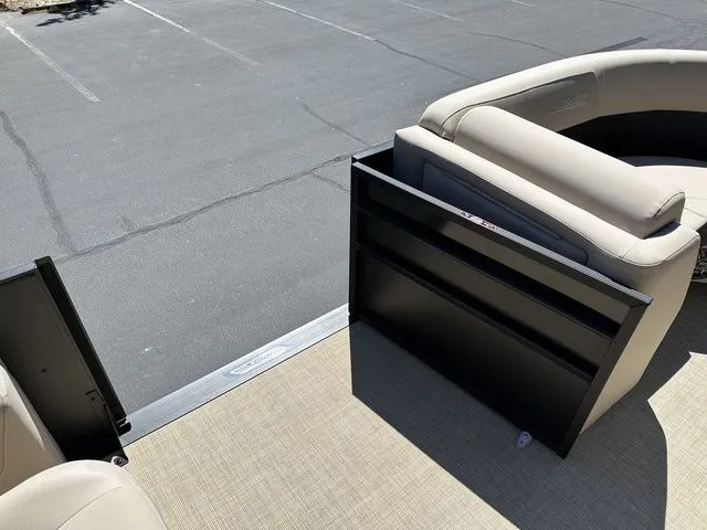 Slide: The Image of 2025 Harris Cruiser 210 CWDH boat interior with beige seating and open gate. - 35