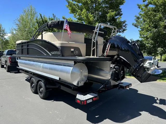 Slide: The Image of 2025 Harris Cruiser 210 CWDH pontoon boat on trailer, parked outdoors. - 5