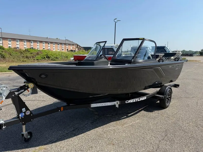 Slide: The Image of 2026 Crestliner 1750 Fish Hawk WT JS boat on trailer in parking lot. - 3