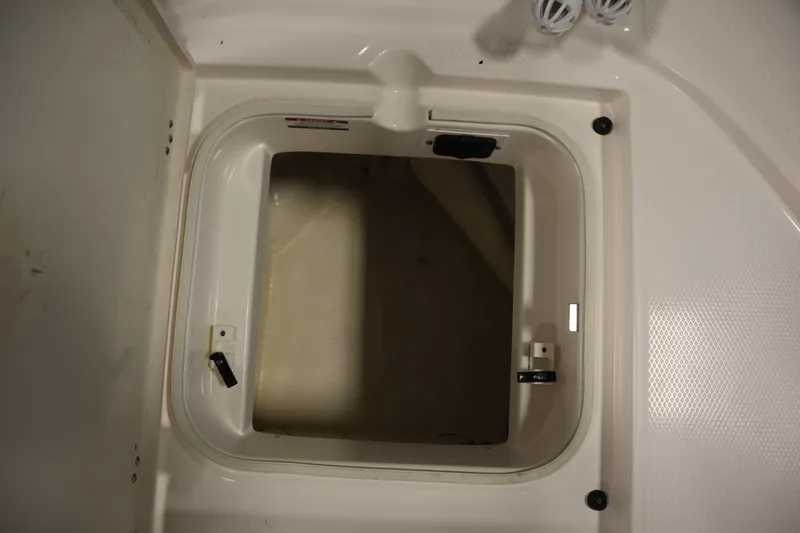 Slide: The Image of Open storage compartment on 2022 Robalo 246 Cayman boat. - 16