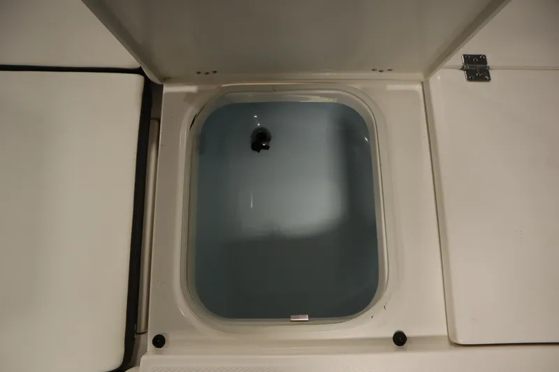 Slide: The Image of Livewell compartment on a 2022 Robalo 246 Cayman boat, open and empty. - 17