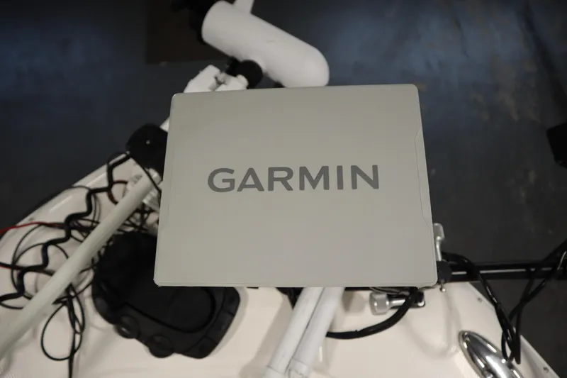 Slide: The Image of Garmin device on 2022 Robalo 246 Cayman boat dashboard, featuring navigation equipment. - 18